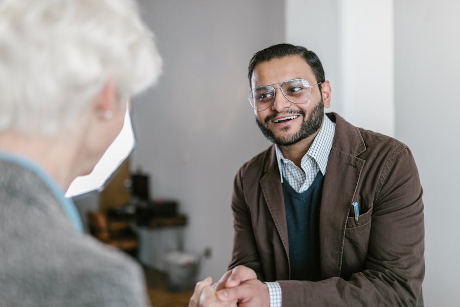 Two business professionals engaged in a friendly handshake indoors.